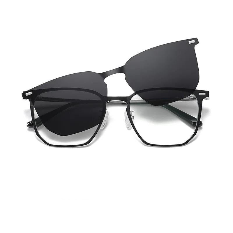 Matte-black geometric metal eyeglasses with clear demo lenses and a detachable magnetic polarized black sun clip. Adjustable silicone nose pads, slim temples with black tips, front view. Discover more at www.zenluk.com