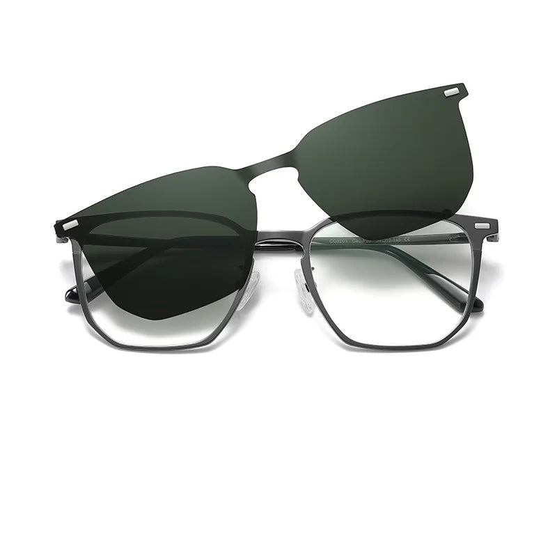 Graphite/grey metal frame with clear lenses and a detachable magnetic deep-green polarized sun clip. Lightweight build, silicone pads, slim arms, straight-on view. See more at www.zenluk.com
