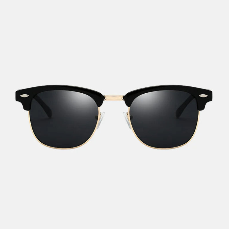 Sunglasses Ruby Black – featuring a bold black upper frame paired with a refined gold metal rim, creating a timeless and sophisticated semi-rimless Clubmaster style. The dark black polarized lenses offer full UV protection, while the adjustable silicone nose pads and sleek black temple arms ensure maximum comfort and a secure fit. Discover this statement piece at www.zenluk.com.